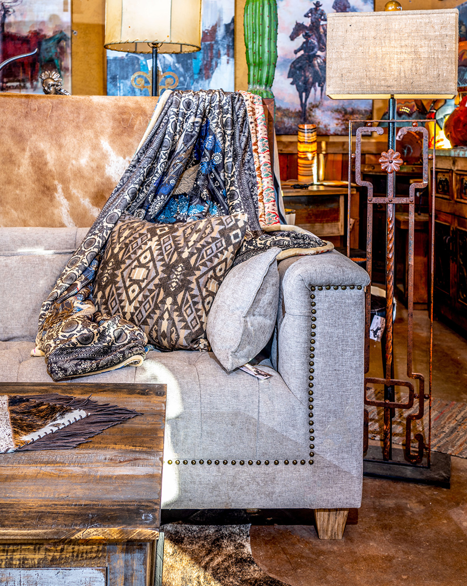 Blanket draped over a couch with southwestern interior